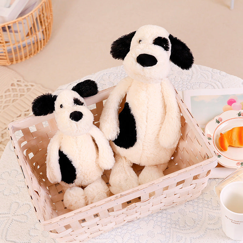 Bashful black and cream puppy plush toy set in woven basket, two sizes, ultra soft spotted stuffed dog for cuddling